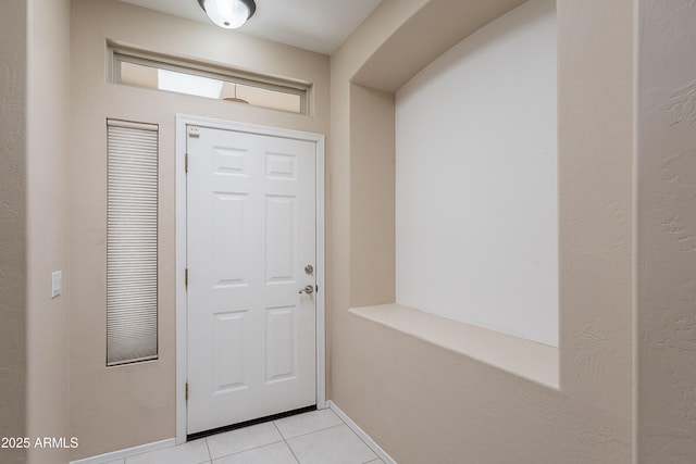 entryway featuring light tile patterned floors and baseboards