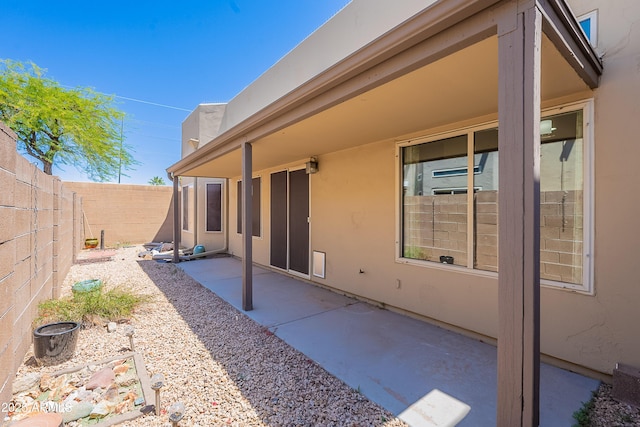 back of property featuring a fenced backyard, stucco siding, and a patio area