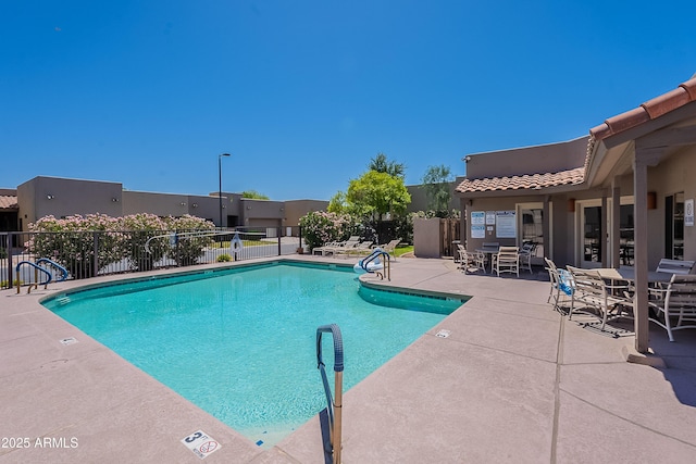 pool with fence and a patio area