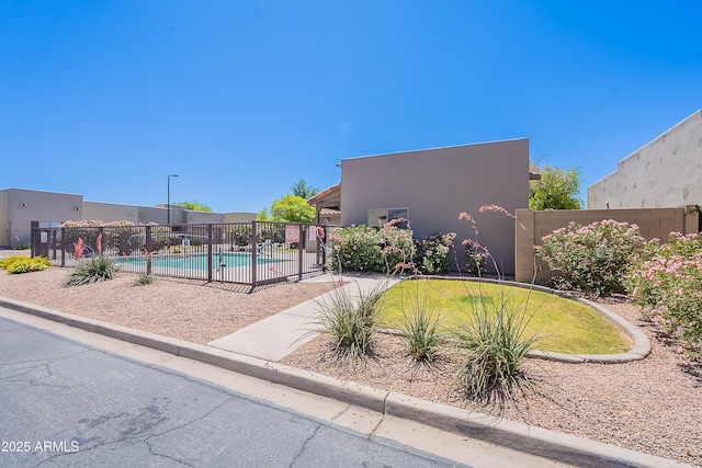 view of home's community with a swimming pool and fence