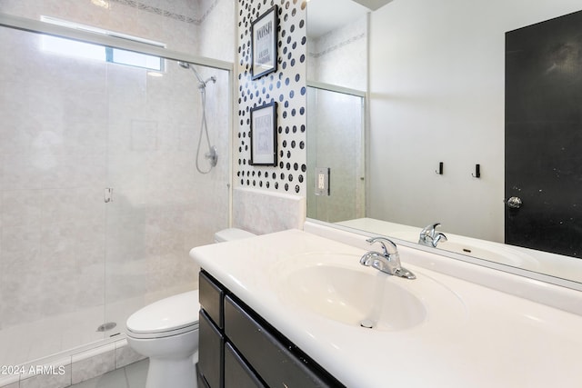 full bathroom featuring a shower stall, vanity, and toilet