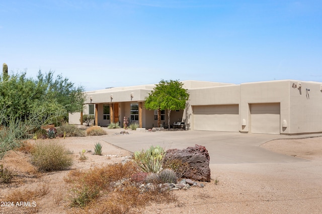 pueblo-style house with a garage