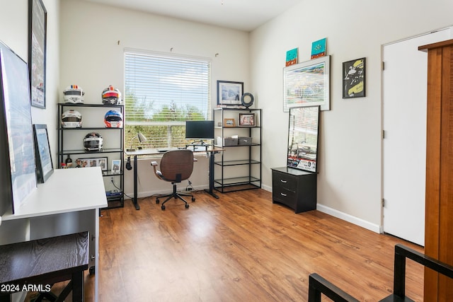 home office with baseboards and wood finished floors