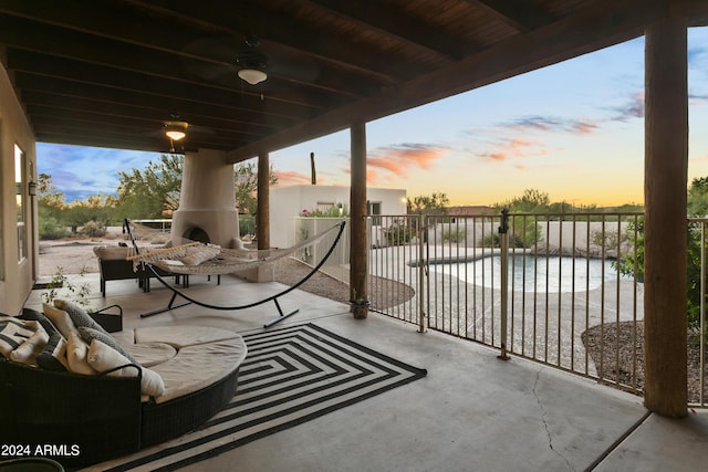 view of patio / terrace featuring a water view, fence, and a fenced in pool