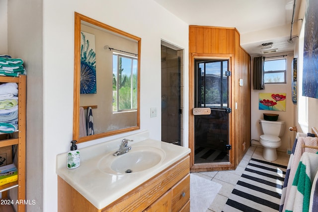 bathroom featuring visible vents, toilet, a stall shower, vanity, and tile patterned floors