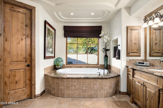 bathroom featuring vanity and tiled bath