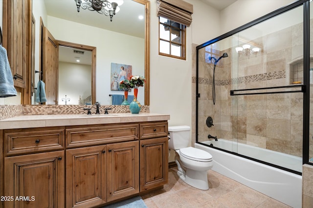 full bathroom with vanity, toilet, and combined bath / shower with glass door