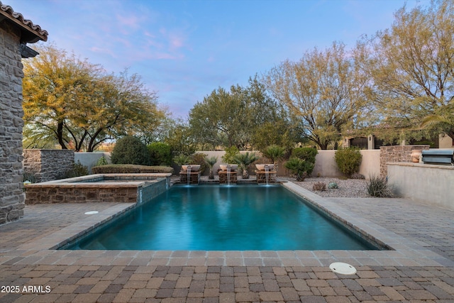 view of pool featuring an in ground hot tub and a patio area