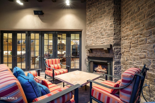 view of patio / terrace with french doors and an outdoor living space with a fireplace