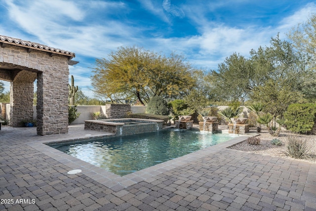 view of pool featuring a patio area and an in ground hot tub