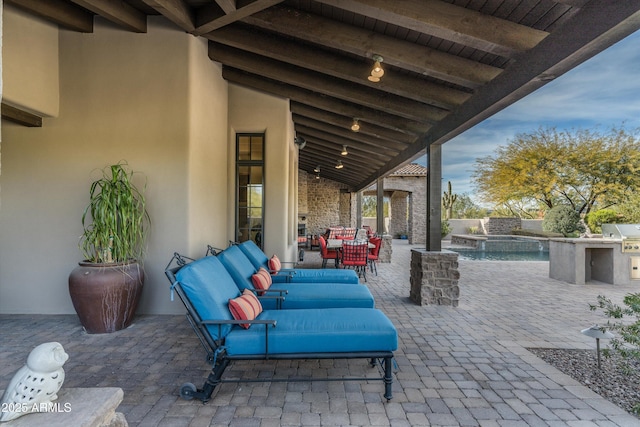 view of patio / terrace with a fenced in pool, outdoor lounge area, and an outdoor kitchen