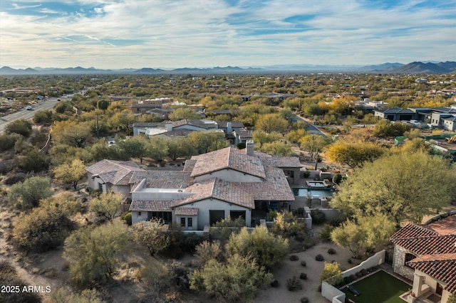 birds eye view of property with a mountain view