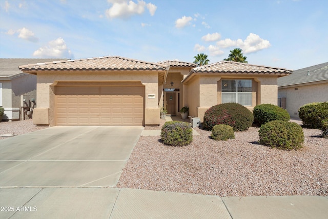 view of front of property with a garage, concrete driveway, a tiled roof, and stucco siding