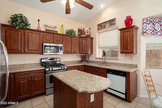 kitchen with a kitchen island, vaulted ceiling, stainless steel appliances, a sink, and light tile patterned flooring