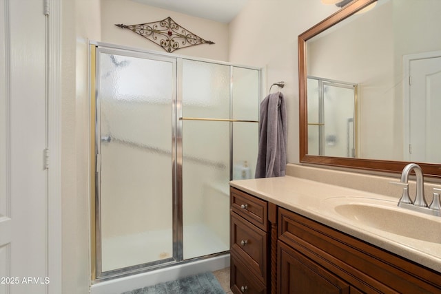 full bath featuring a stall shower and vanity