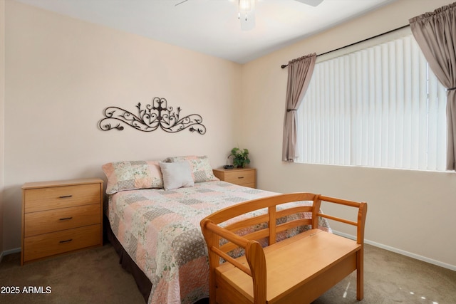 carpeted bedroom with a ceiling fan and baseboards