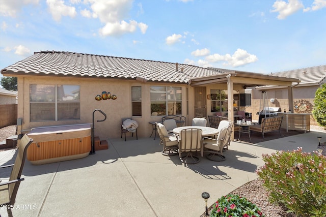 view of patio featuring outdoor dining space, an outdoor living space, and a hot tub