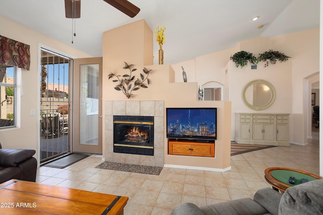 living area featuring tile patterned flooring, baseboards, and a tile fireplace