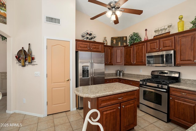 kitchen featuring a center island, visible vents, appliances with stainless steel finishes, light tile patterned flooring, and ceiling fan