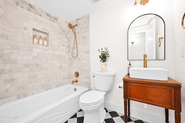 bathroom with tile patterned floors, toilet, shower / bathing tub combination, baseboards, and vanity