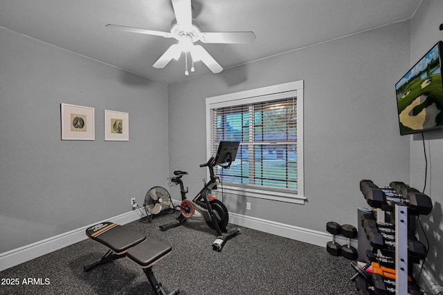 exercise room with ceiling fan and baseboards