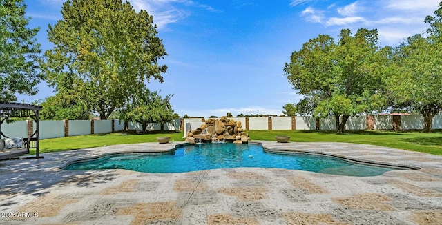 view of swimming pool featuring a patio, a yard, and a fenced backyard