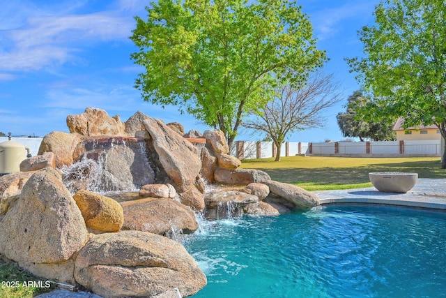 view of swimming pool with a yard, fence, and a fenced in pool