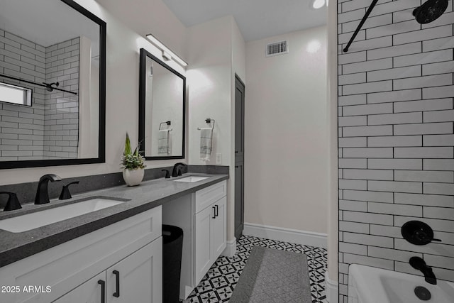 bathroom with double vanity, visible vents, shower / bath combination, and a sink