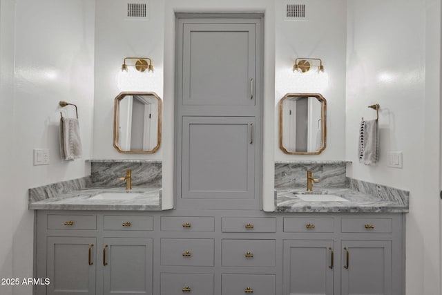 full bathroom with a sink, visible vents, and double vanity