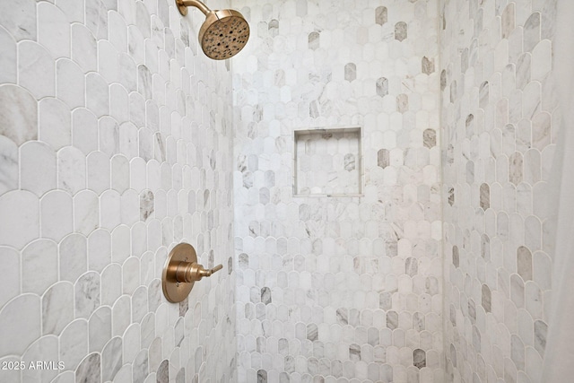 interior details with a tile shower