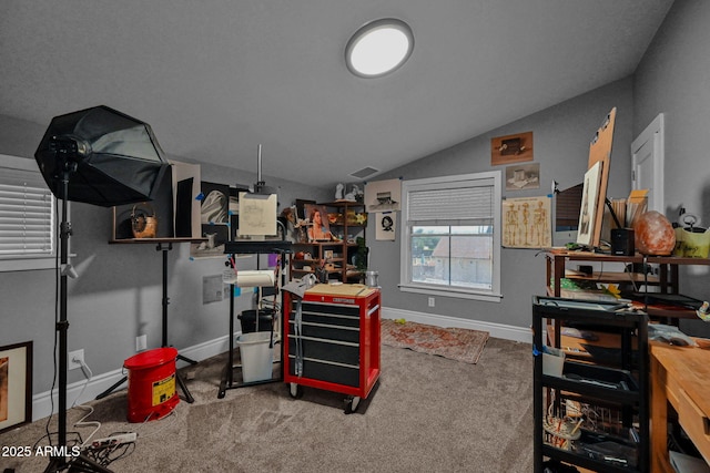 interior space with visible vents, baseboards, and vaulted ceiling