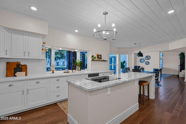 kitchen featuring a center island, dark wood-type flooring, white cabinets, black electric cooktop, and open shelves