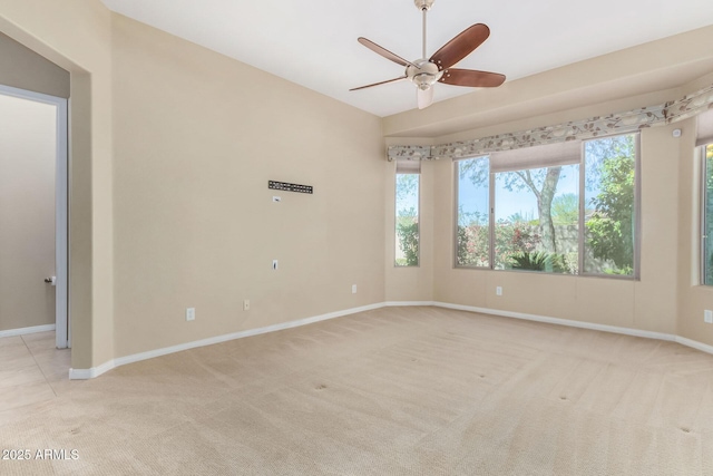 carpeted spare room featuring plenty of natural light, vaulted ceiling, and ceiling fan