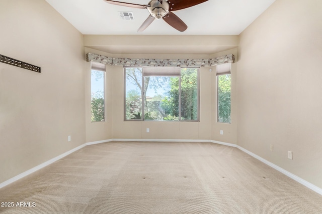 carpeted empty room featuring ceiling fan and a healthy amount of sunlight