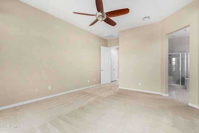 spare room with light colored carpet and ceiling fan