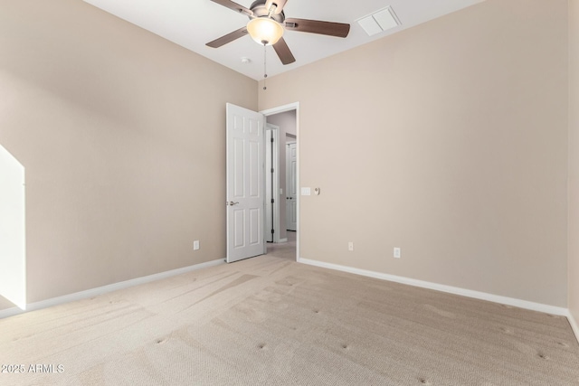 carpeted spare room featuring ceiling fan