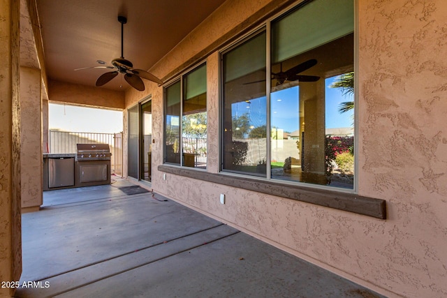 view of patio with ceiling fan and an outdoor kitchen