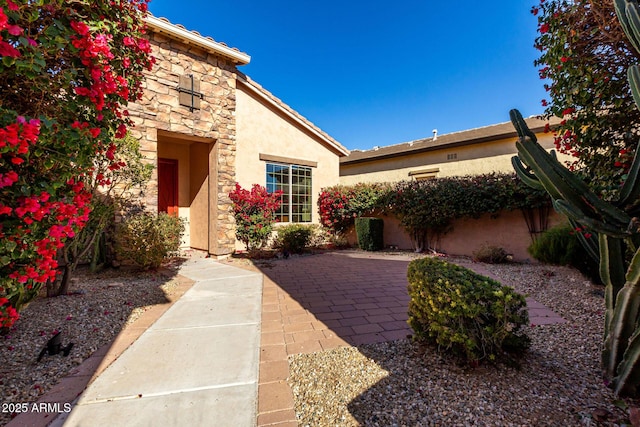 entrance to property featuring a patio area