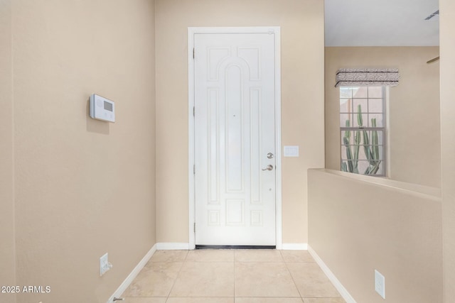 doorway with light tile patterned floors