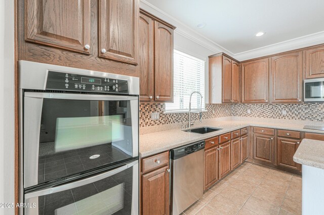 40232 W Marion May Ln, Maricopa, AZ 85138 - kitchen featuring stainless steel appliances, a sink, ornamental molding, tasteful backsplash, and light tile patterned flooring