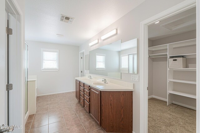 40232 W Marion May Ln, Maricopa, AZ 85138 - full bathroom with healthy amount of natural light, double vanity, baseboards, and tile patterned flooring
