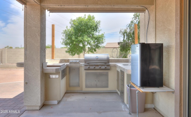 40232 W Marion May Ln, Maricopa, AZ 85138 - view of patio / terrace with an outdoor kitchen, grilling area, and fence