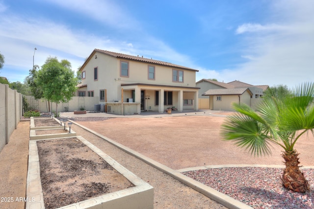 40232 W Marion May Ln, Maricopa, AZ 85138 - view of front of home with fence, stucco siding, a patio, a garden, and central air condition unit