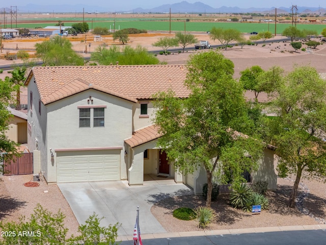 40232 W Marion May Ln, Maricopa, AZ 85138 - view of front of property featuring a tile roof, a mountain view, stucco siding, an attached garage, and driveway