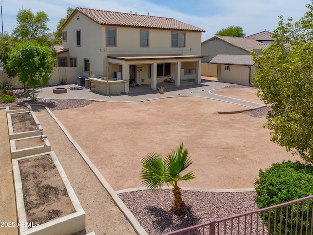 40232 W Marion May Ln, Maricopa, AZ 85138 - rear view of property with stucco siding, an outdoor fire pit, a fenced backyard, a patio area, and a tile roof