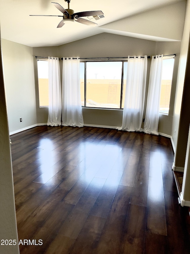5749 S 247th Dr, Buckeye, AZ 85326 - empty room with a ceiling fan, vaulted ceiling, healthy amount of natural light, and dark wood-type flooring