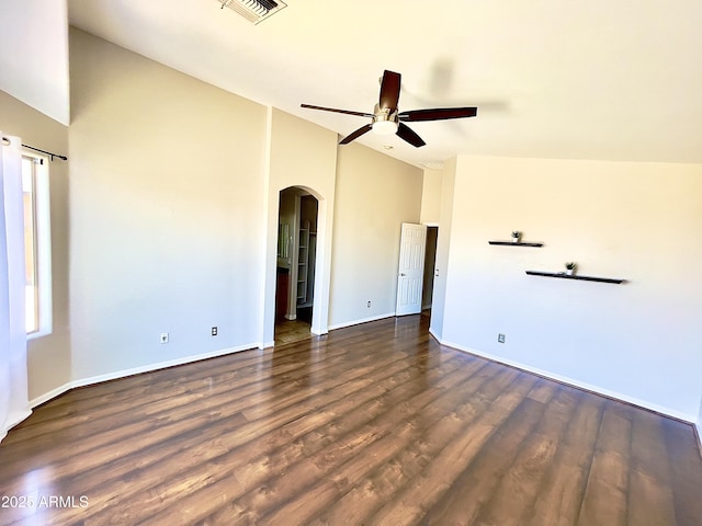 5749 S 247th Dr, Buckeye, AZ 85326 - spare room with arched walkways, a ceiling fan, dark wood finished floors, baseboards, and high vaulted ceiling