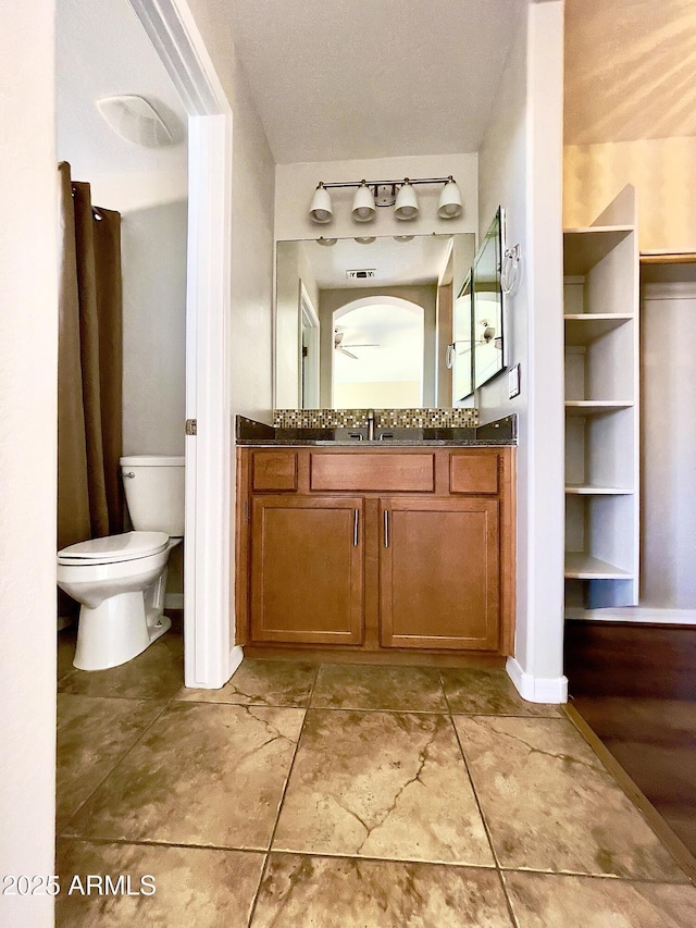 5749 S 247th Dr, Buckeye, AZ 85326 - bathroom with toilet, vanity, a ceiling fan, and baseboards