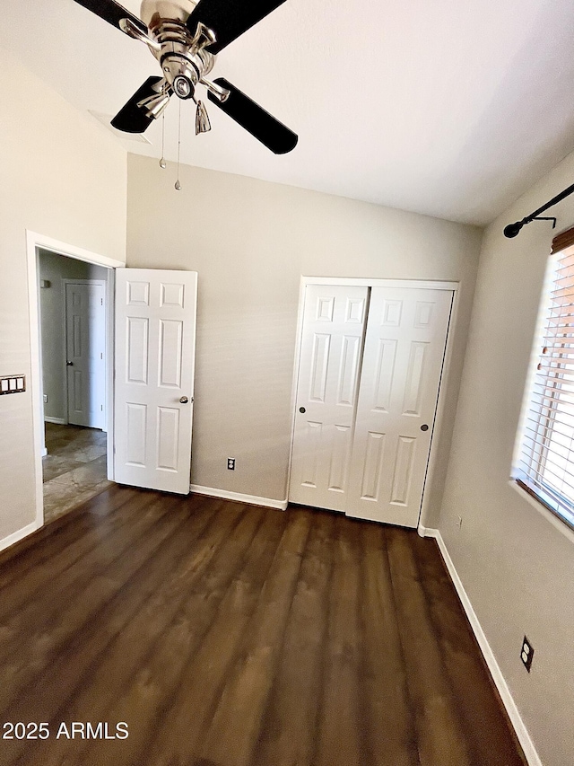 5749 S 247th Dr, Buckeye, AZ 85326 - unfurnished bedroom featuring dark wood-type flooring, baseboards, a closet, and ceiling fan