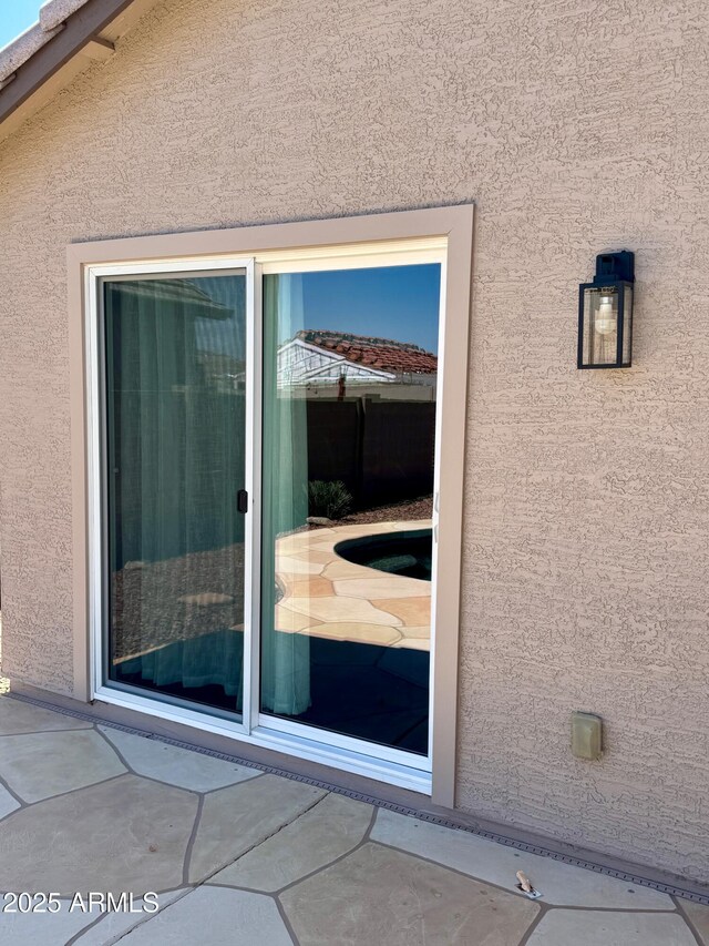 5749 S 247th Dr, Buckeye, AZ 85326 - doorway to property featuring stucco siding and a patio
